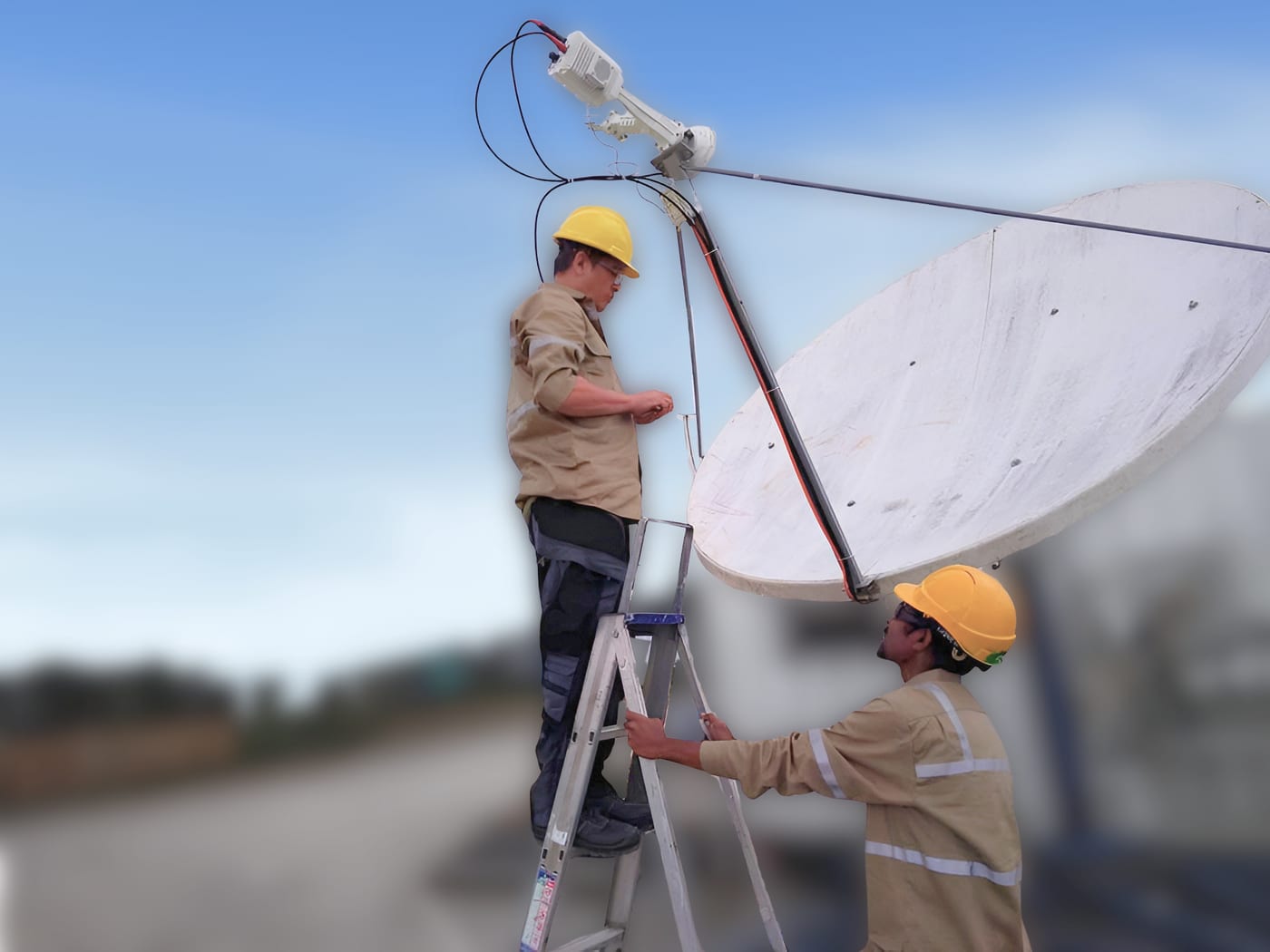Two Cygnal field technicians installing a satellite dish